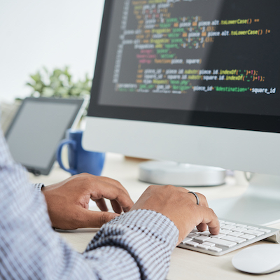Cropped image of It specialist working on code